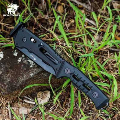 HXOFT19 — Hachette Pliante HX Outdoors Falcilux Lame Acier DC53 Noire Manche G10 Coffret Étanche - Livraison Gratuite