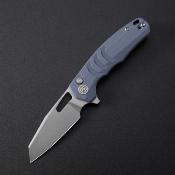 PKFE17BW Petrified Fish Trilobite | Couteau Lame Reverse Tanto Acier Sandvik 14C28N | Manche Blue G10 Button Lock - Livraison Gratuite